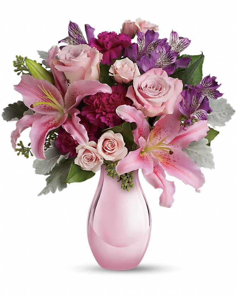 Enchanting Pinks by Teleflora - Imagine her joy when she opens the door and sees this incredible array of roses, lilies and other favorites in an elegant pink reflections vase. She'll be talking about it for weeks. The exquisite bouquet includes pink roses, light pink spray roses, light pink oriental lilies, purple alstroemeria and fuchsia carnations accented with assorted greenery. Delivered in Teleflora's exclusive pink reflections vase.