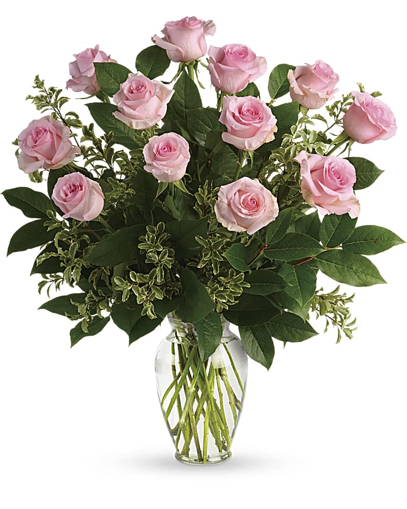 Say Something Sweet Bouquet - Say it sweeter with this feminine bouquet of a dozen ballet pink roses and lush greens in a graceful glass vase. 12 pink roses are arranged with pitta negra and lemon leaf. Delivered in a clear glass vase.