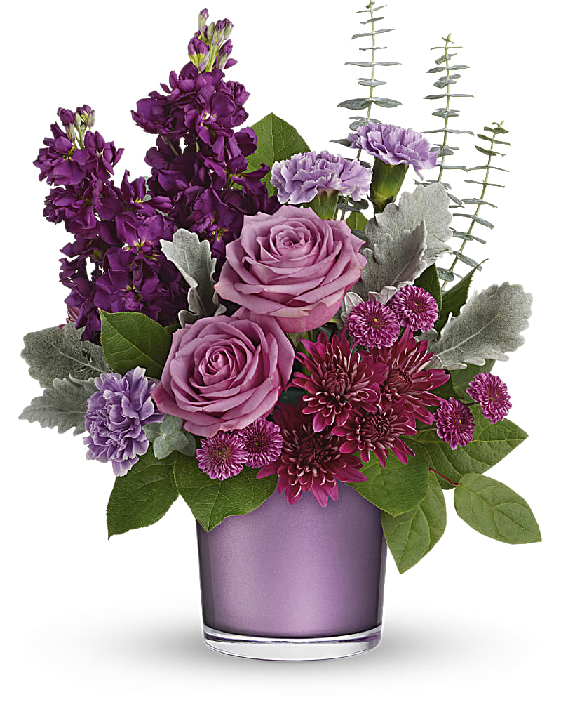 Teleflora's Always Amethyst Bouquet - Spoil your special someone with the purple luxury of this gorgeous gift! Presented in a shimmering purple amethyst-colored vase, this radiant rose bouquet is a lustrous choice for any occasion. This pretty bouquet includes lavender roses, lavender carnations, lavender stock, purple cushion spray chrysanthemums, purple button spray chrysanthemums, dusty miller, seeded eucalyptus, and lemon leaf. Delivered in a Purple Amethyst Polished Gem Cylinder.