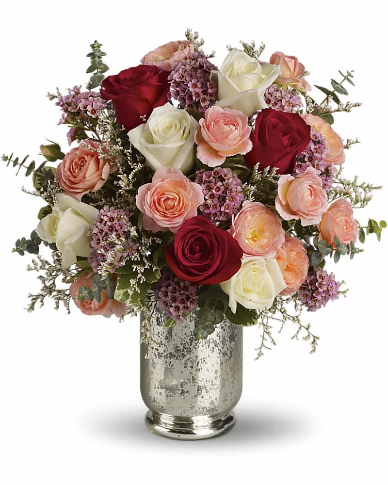 Teleflora's Always Yours Bouquet - Let her know that you are always hers by sending this enchanting rose bouquet. It offers red roses for romance, white roses for loyalty, and coral to convey desire. What's more, this stunning arrangement is elegantly hand-delivered in a silver mercury glass hurricane vase. Pastel roses and spray roses, pink waxflower, white limonium and stylish eucalyptus are delivered in a divine vase. This beauty definitely says love always.