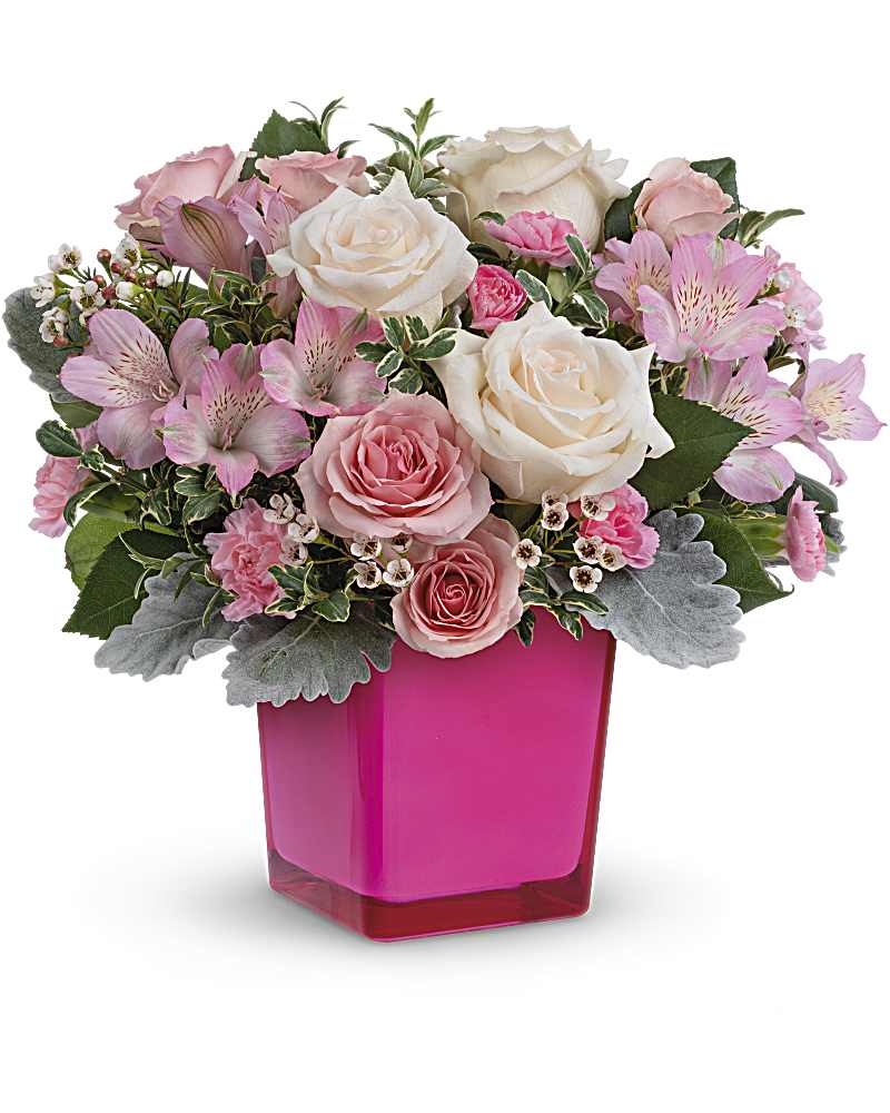 Teleflora's Be The Moment Bouquet - Celebrate special moments with a gift of beautifully feminine blooms, hand-delivered in a glass cube that's a charming candleholder for years to come. CrÃ¨me roses, pink spray roses, pink alstroemeria and miniature pink carnations are arranged with white waxflower, dusty miller and oregonia. Delivered in a Color Splash Cube.