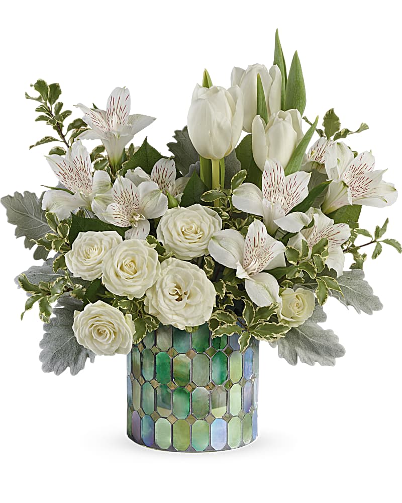 Teleflora's Divine Mosaic Bouquet - Your message of peace and serenity will be delivered with this elegant bouquet of white blooms featured in a marvelous stained glass cylinder vase. A peaceful bouquet of white tulips, white alstroemeria, and white spray roses accented with dusty miller and pitta negra.