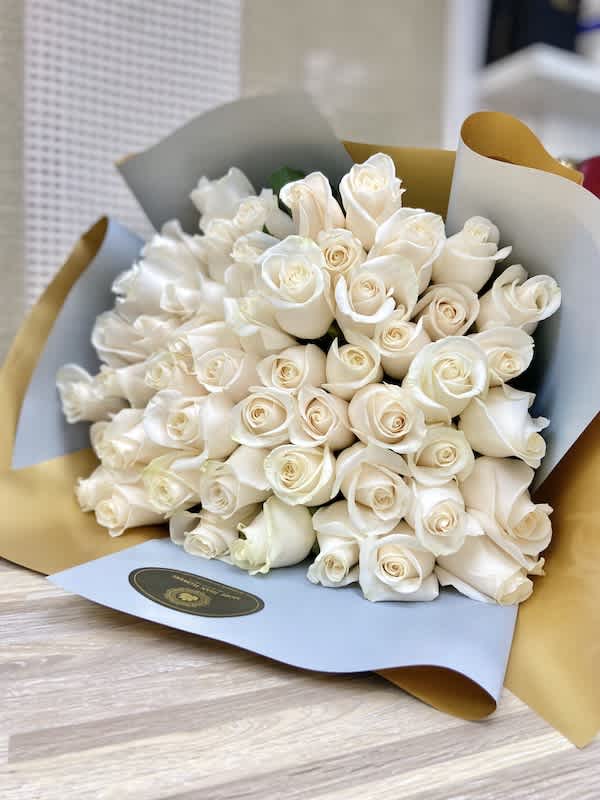 50 Roses Handheld Round Bouquet - White Roses - 50 Roses Handheld Round Bouquet: Artistically wrapped in our special Euro Floral paper accented with a decorated bow and completed with a personalized card message. Contact us for color availability. (NO VASE INCLUDED)