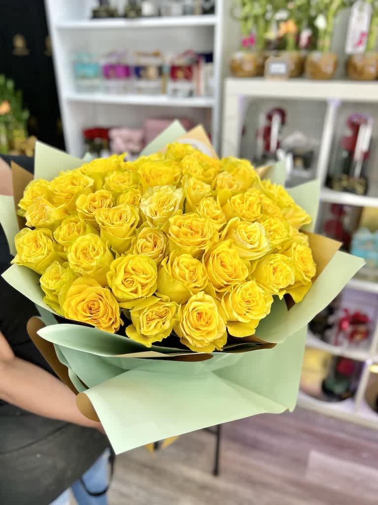 50 Roses Handheld Round Bouquet - Yellow - 50 Roses Handheld Round Bouquet: Artistically wrapped in our special Euro Floral paper accented with a decorated bow and completed with a personalized card message. Contact us for color availability. (NO VASE INCLUDED)