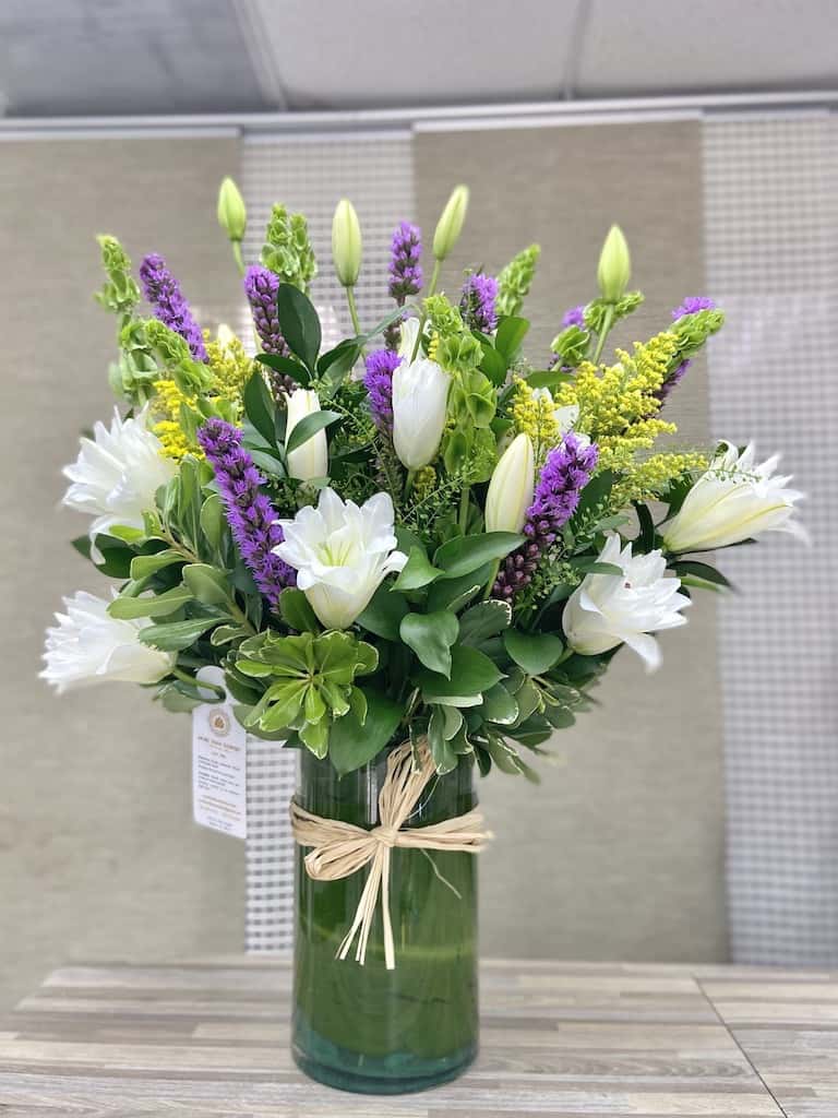 CasaBlanca Lilies Splash Bouquet - Lilies Splash Bouquet: Beautiful white lilies arrangement accented with greens, liatris, fillers, ruscus completed in a clear shape vase and a personalized card message