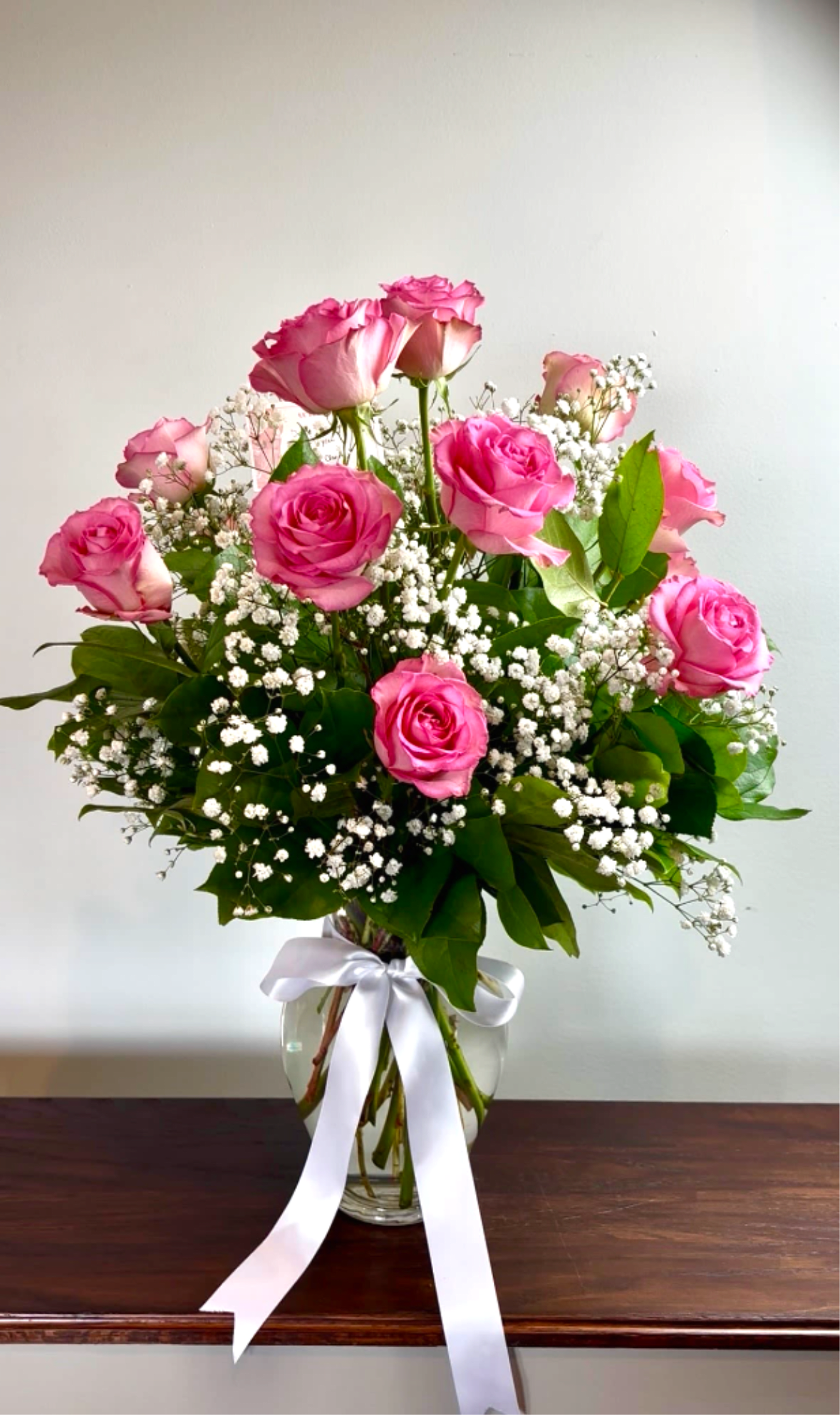 Dozen Long Stemmed Pink Roses by BloomNation™ - These pink roses are cheerful and fun! Dozen Long Stemmed Pink Roses by BloomNation™ is the perfect gift to show your love and appreciation.  APPROXIMATE DIMENSIONS: 25" H X 18" W  