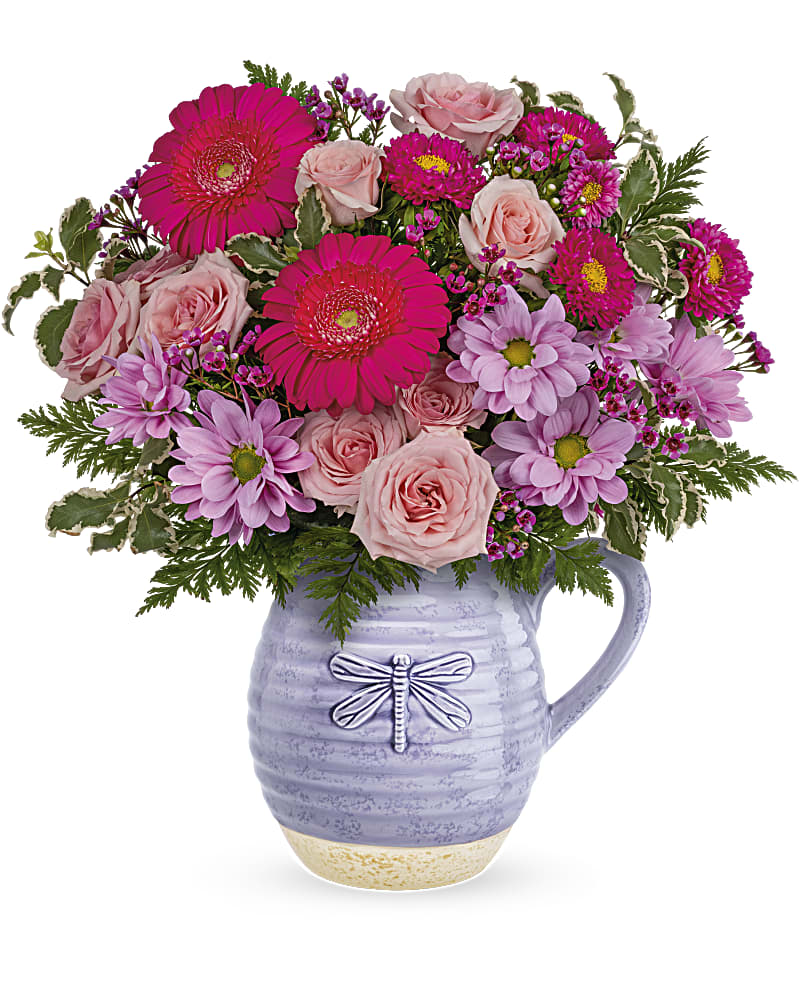 Teleflora's Pour On The Lavender Bouquet - Lovely in lavender! With its beautiful artisanal glaze and whimsical dragonfly, this sweet ceramic pitcher--that's also food-safe!--makes the perfect presentation for a bright pink bouquet. This bouquet features pink spray roses, miniature hot pink gerberas, hot pink matsumoto asters, lavender daisy spray chrysanthemums, lavender waxflower, pitta negra and leatherleaf fern. Delivered in a Whimsical Dragonfly pitcher.