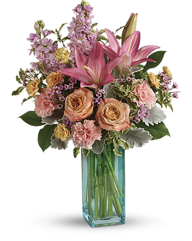 Teleflora's Pretty And Posh Bouquet - Inspired by ocean sunsets, this gorgeous gift of radiant pink and peach blooms and sparkling turquoise glass is sure to delight! Peach roses, pink asiatic lilies, pink carnations, peach miniature carnations, pink stock, pink waxflower are accented with dusty miller, pitta negra, and lemon leaf. Delivered in a Turquoise Bunch vase.