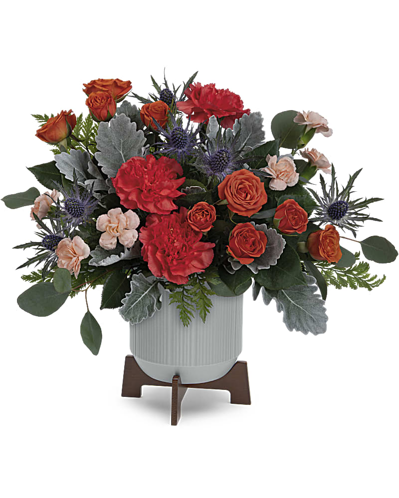 Teleflora's Retro Brights Bouquet - Sure to brighten their day, Teleflora's Retro Brights Bouquet of radiant orange blooms looks sleek in a matte ceramic planter with retro-inspired wooden base. Orange spray roses, orange carnations, miniature peach carnations, blue eryngium and dusty miller are accented with silver dollar eucalyptus and leatherleaf fern. Delivered in a Classic Contemporary planter.