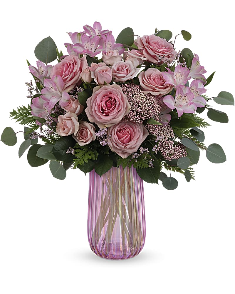 Teleflora's Rosy Iridescence Bouquet - Mom is sure to "pink" up when this pink rose bouquet arrives, beautifully arranged in an iridescent pink glass keepsake vase. Pink roses, pink spray roses, pink alstroemeria and pink rice flower are arranged with leatherleaf fern, pink limonium and silver dollar eucalyptus. Delivered in an Iridescent Delight vase.