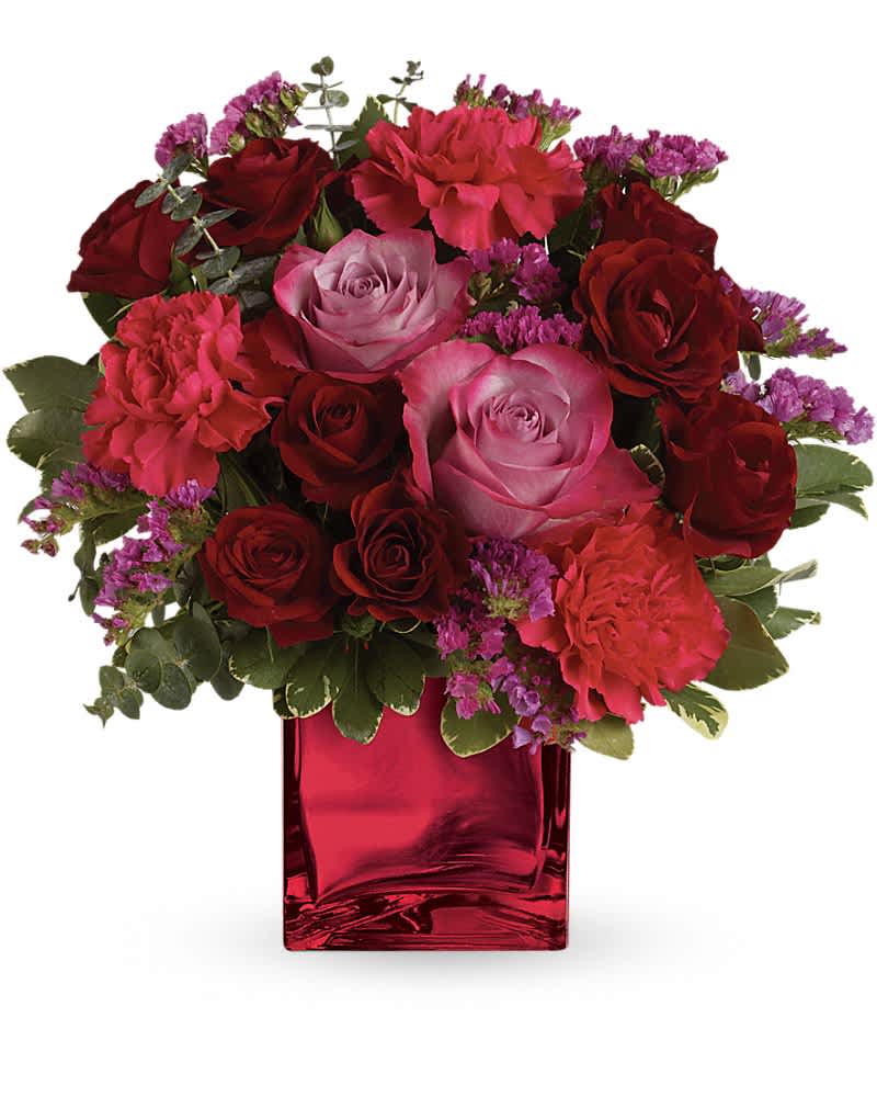 Teleflora's Ruby Rapture Bouquet - Enrapture your paramour with this dramatic display of red and lavender roses. This bouquet is arranged in a red, mirrored glass cube - a shining keepsake they'll treasure forever. Includes red and lavender roses, hot pink carnations and assorted fresh greens. Delivered in a Mirrored Cube.