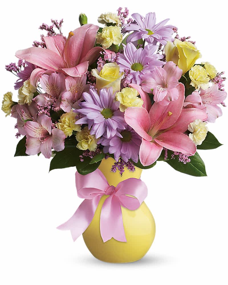 Teleflora's Simply Sweet - Sometimes life's simplest pleasures deliver life's most poignant feelings. Take this sweet bouquet. Soft colors, beautiful flowers in a yellow vase that's wrapped in a pretty pink satin bow. Simple? You bet. Special? For sure! Light yellow roses, pink asiatic lilies and alstroemeria, light yellow miniature carnations, lavender daisy spray chrysanthemums and pink limonium are gorgeously arranged in a pretty yellow vase, complete with a satin bow. Sweeter than sweet!