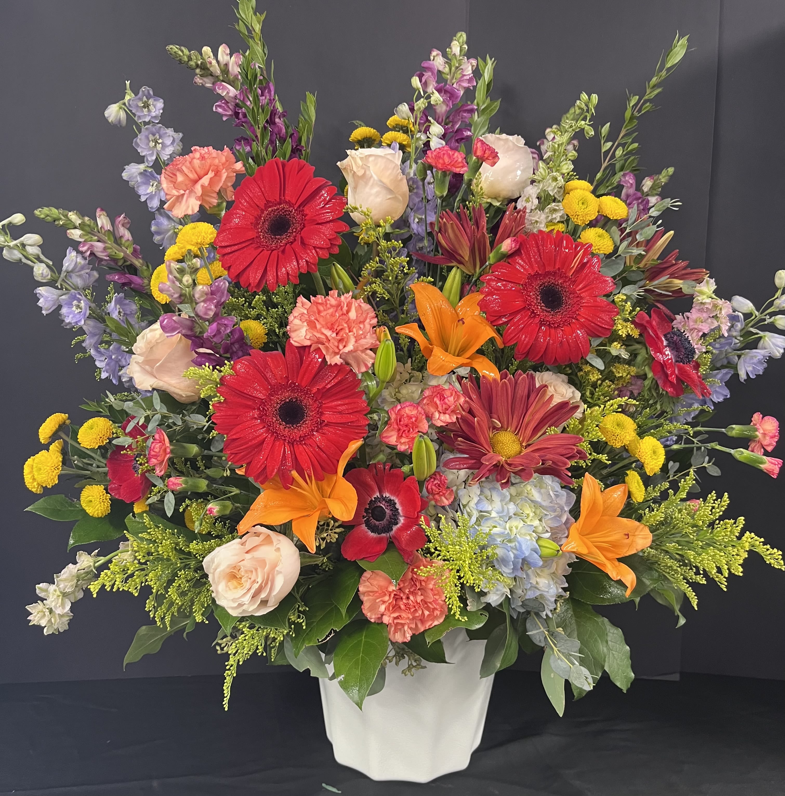 Meadow of Memories - This arrangement is created with beautiful blooms that seem like they came from the meadow. The flowers used will vary according to availability. but the over all theme will be the same. 