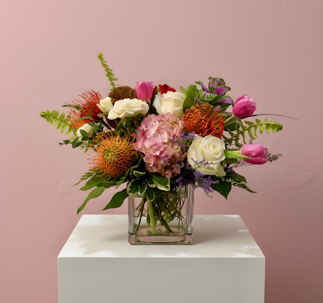 Petal Pop Fireworks - A vibrant arrangement featuring striking pincushions surrounded by soft pink and white blooms. Bold, playful, and full of movement — like a burst of petals lighting up the sky in celebration. 