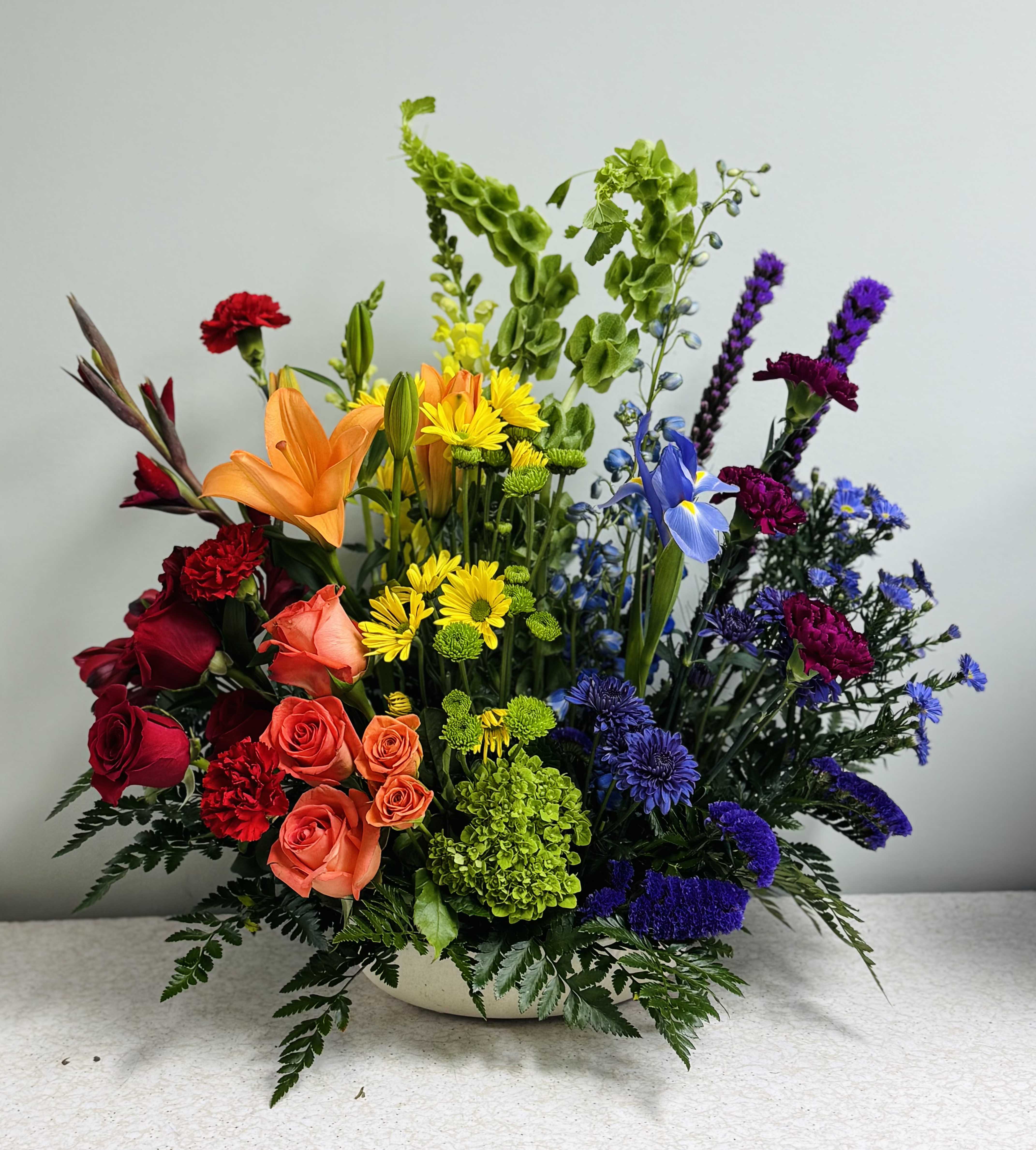 Colorful mixed flower arrangement in a low white bowl