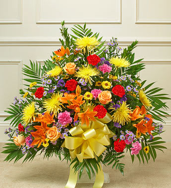 Heartfelt Tribute Bright Floor Basket Arrangement - Share your most sincere expression of sympathy during a difficult time with this tasteful and elegant floor basket arrangement. Our expert florists hand arrange the freshest gathering of roses, spray roses, Gerberas, alstroemeria and more in shades of red, orange, yellow, pink and purple to help you convey your care and support while letting them know that brighter days are ahead