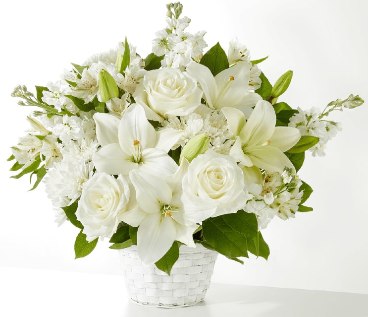 Peaceful Reflection - An arrangement of alstroemeria, chrysanthemums cushion, stock, roses, lily, and white basket.