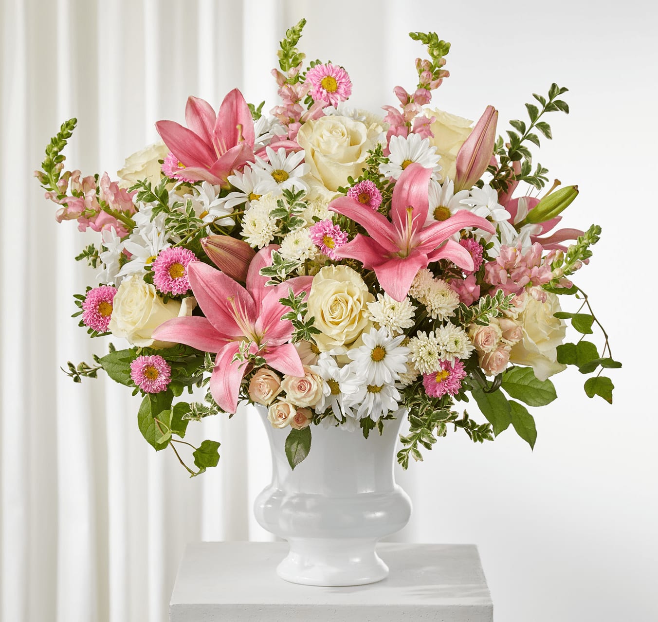 Empathic - Full of blushing blooms, the Empathetic Blooms Urn Arrangement makes a beautiful table piece for a service or the home.
