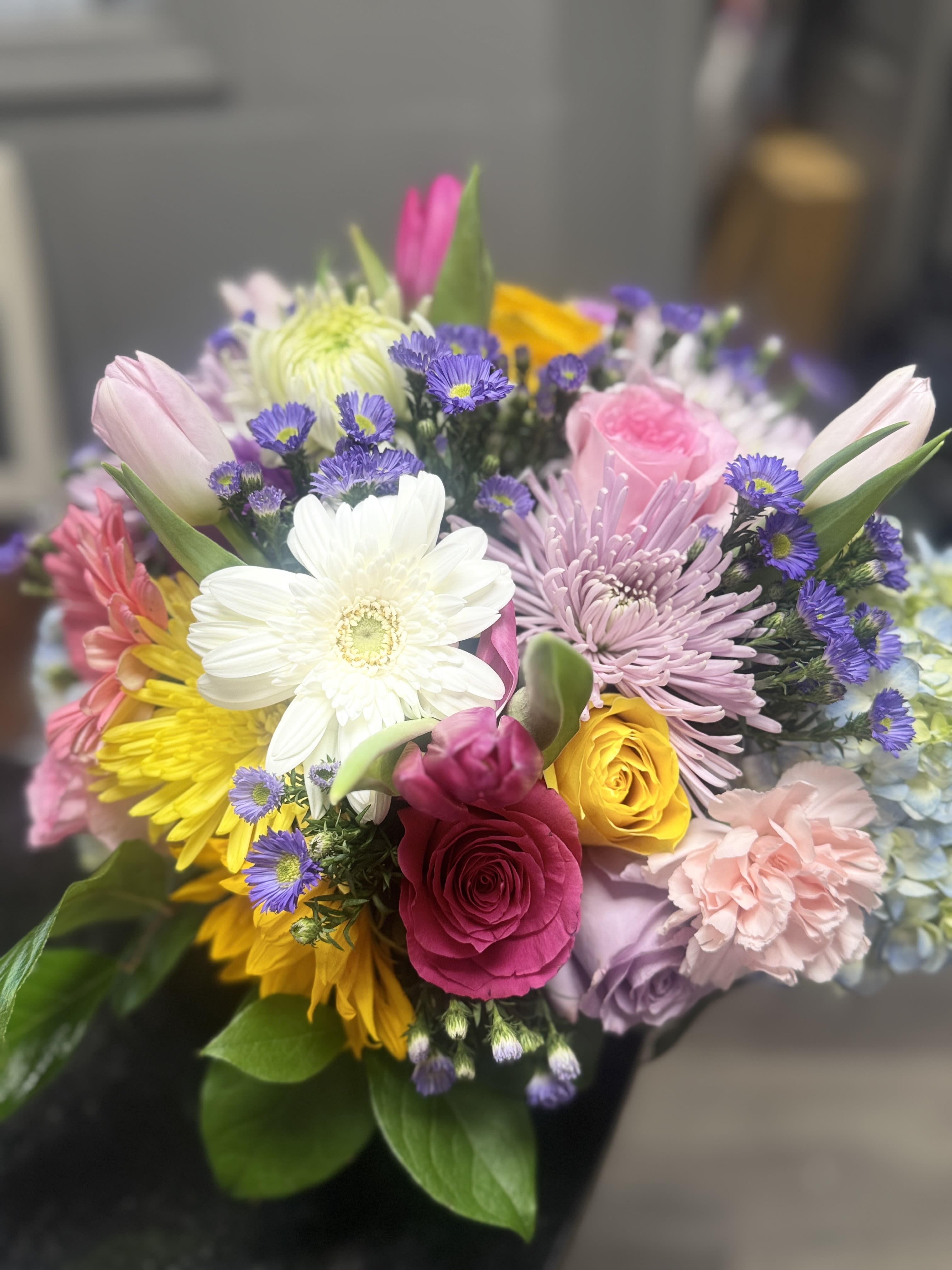 Pastel Surprise - A soft pink colored floral with pops of lavender, yellow and white mix of flowers for any occasion.