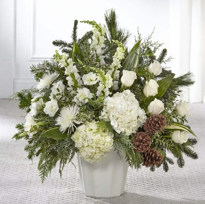 The FTD® Heavenly Love™ Floor Basket  - A display of pure white flowers offers your sentiment in a meaningful way when you cannot find the words. Beautiful assorted seasonal greens add texture to an array of hydrangea, roses, lisianthus and Fuji mums. A rustic accent of pinecones completes our stunning Heavenly Love™ Floor Basket with comfort and warmth.   Details:  o Good basket is approximately 29"H x 27"W   o Better basket is approximately 34"H x 31"W 