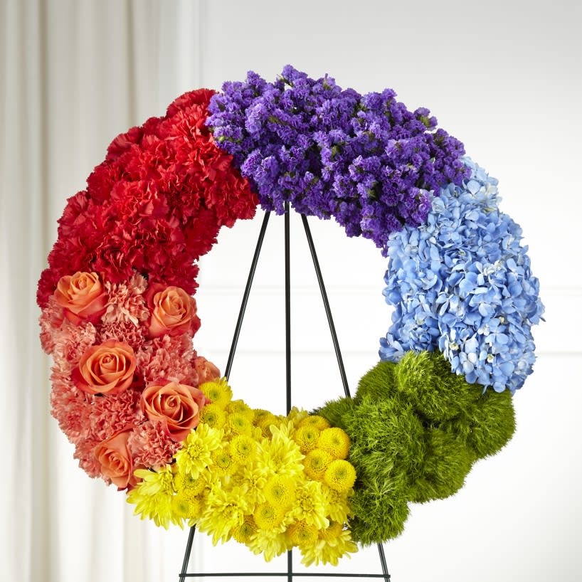 The FTD® Circle of Love™ Wreath  - Deliver your sympathy in a thoughtful and supportive way with our beautiful Circle of Love™ Wreath. This bold, colorful collection of blooms handcrafted by a local florist celebrates and commemorates the life of a lost loved one.  Details: o Wreath is approximately 23" in diamete