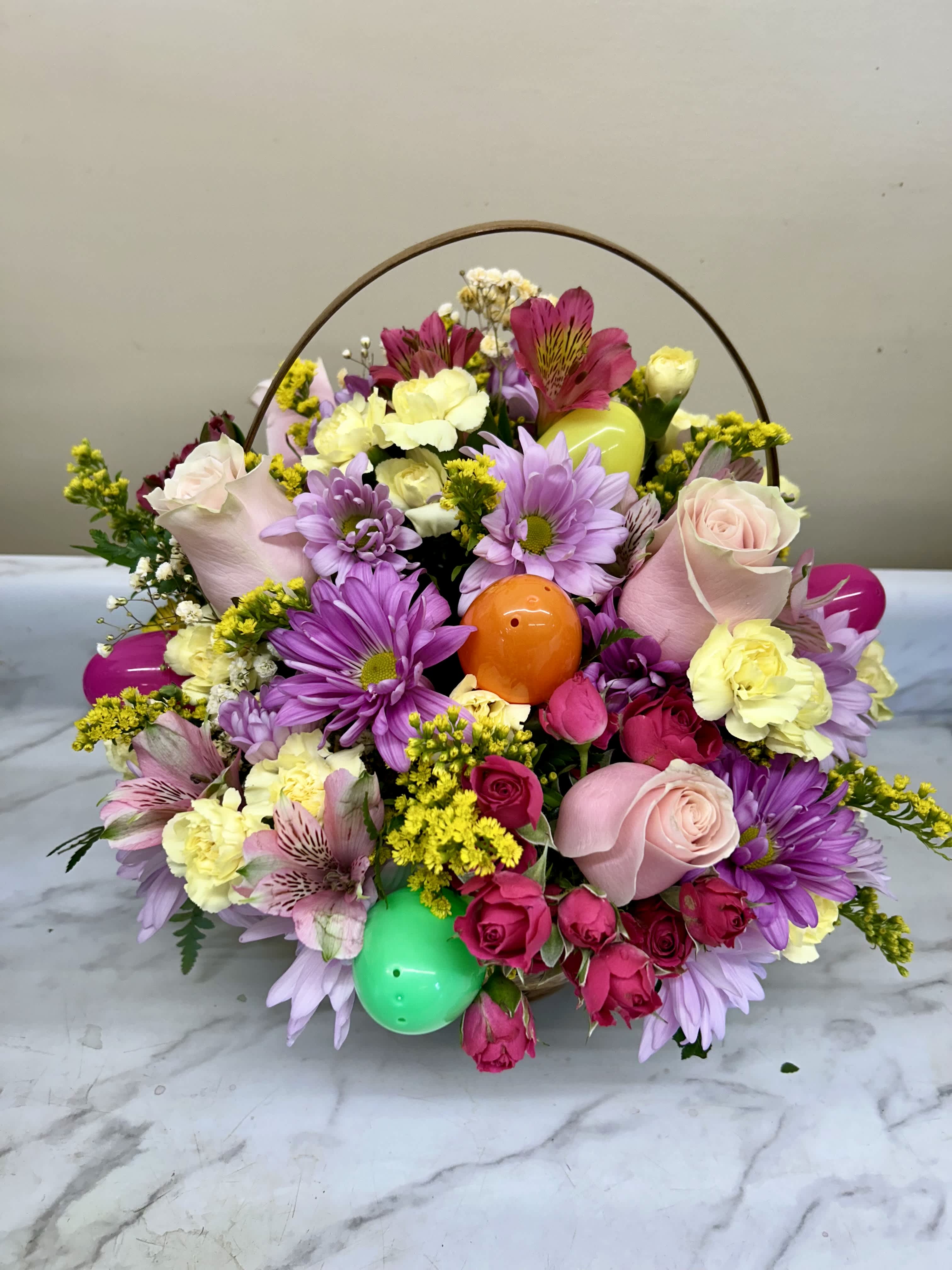 Easter egg basket - Mixed daisies, carnations, roses and alstroemeria with eggs in a basket 
