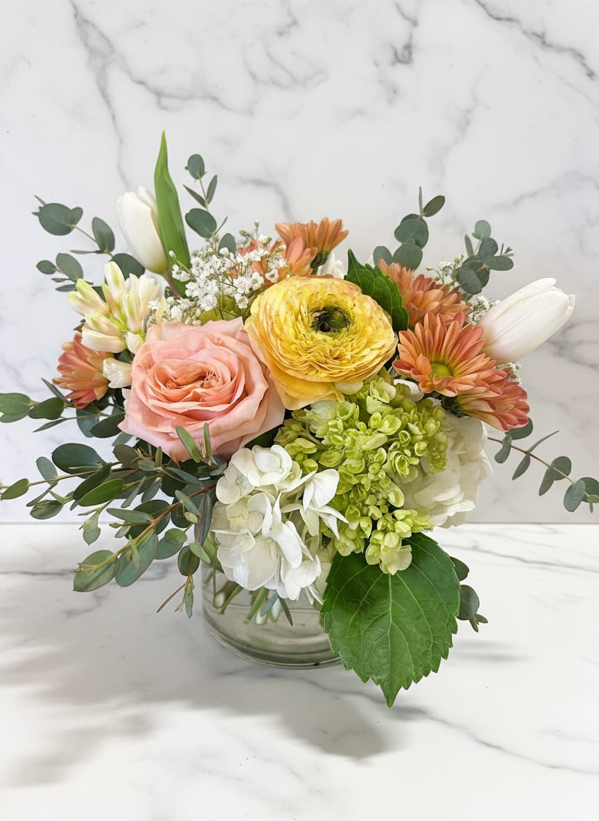 THE PASTEL JASMINE - Just picked from the garden pastel toned flowers in a cylinder or cube vase. Perfect for any occasion! Our designers will use the freshest most beautiful flowers in shop.  