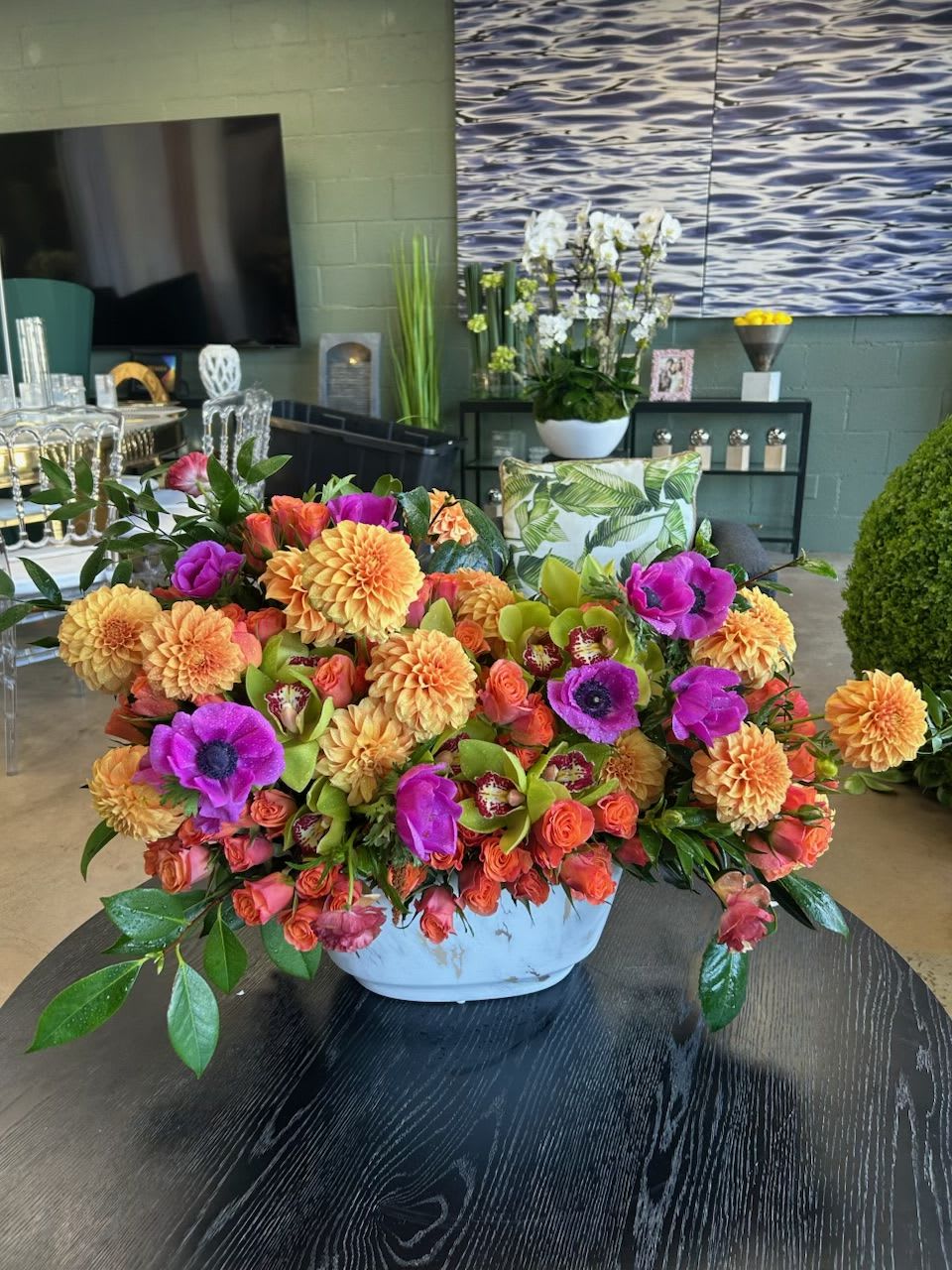 Sunset - This beautiful ceramic vase arrangement is bursting with rich, warm colors to evoke the majestic California sunset! Featuring Dahlias, Spray Roses, Anemones, and Cymbidium Orchids