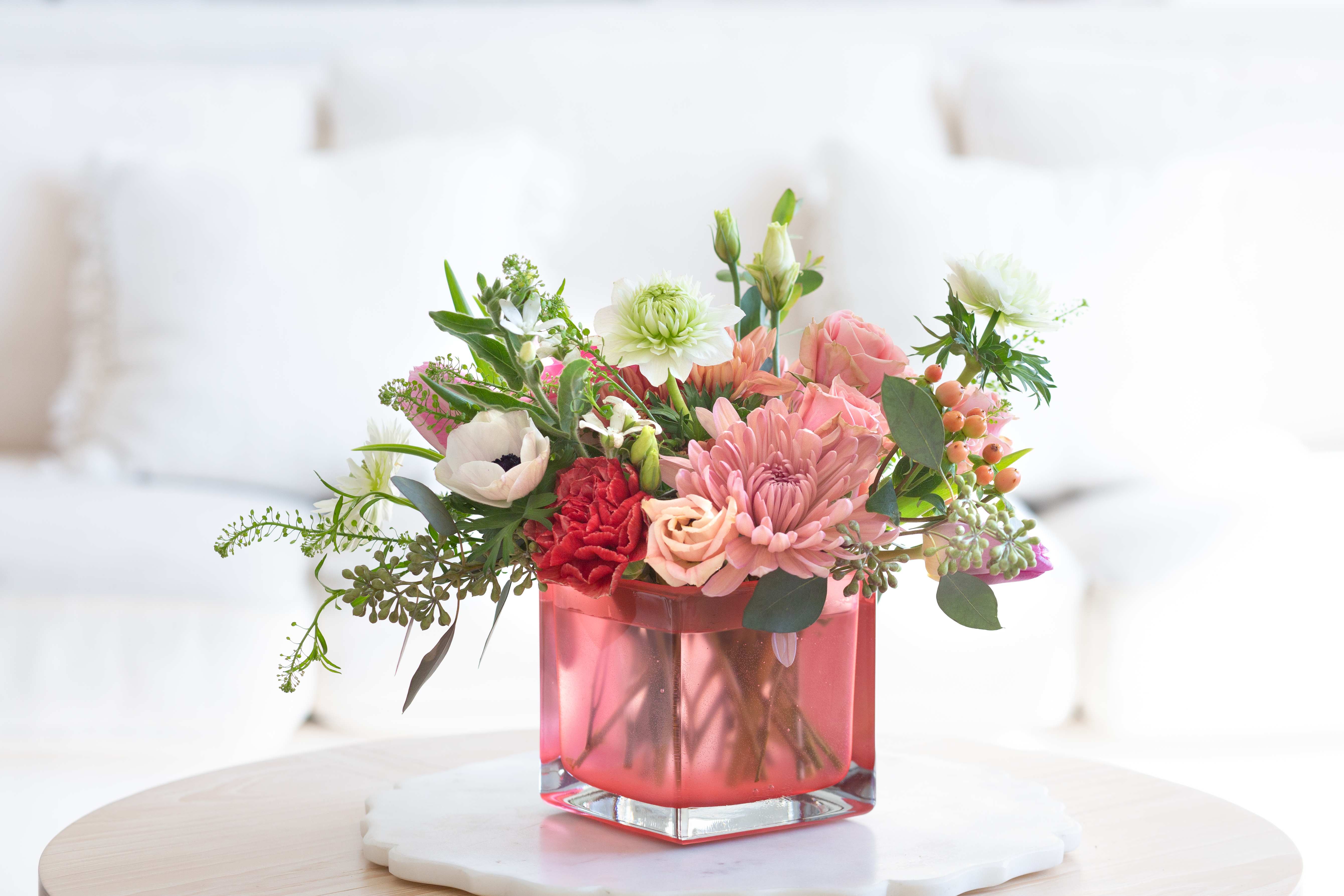 You Are So Beautiful – Garden Bloom Arrangement - Bright, joyful, and full of charm, You Are So Beautiful is a vibrant spring floral design created to celebrate the people who make life brighter.  This cheerful arrangement features a lively palette of coral, blush pink, soft peach, and fresh greens arranged in a modern translucent coral glass vase. Seasonal blooms such as roses, chrysanthemums, carnations, lisianthus, anemones, and delicate textural accents come together in a playful garden-style composition that feels fresh, warm, and full of life.  The glowing coral vase adds a modern touch while highlighting the rich colors of the flowers, creating a design that feels both stylish and gift-ready. Airy greenery and berries provide movement and texture, giving the arrangement a natural garden feel.  Handcrafted by the designers at ImpeKable Flowers in DeLand, each piece is created with carefully selected seasonal blooms sourced from premium growers.  A wonderful choice for Mother’s Day, birthdays, thank-you gifts, celebrations, or simply letting someone know how beautiful they are.  We proudly offer flower delivery throughout DeLand, Lake Mary, Sanford, Deltona, Orange City, DeBary, Altamonte Springs, and surrounding Central Florida communities.  Flower varieties may vary slightly depending on seasonal availability while maintaining the same color palette and overall design style. 