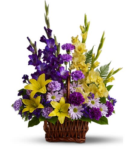 Basket of Memories - DG218-3A - Honor rich remembrances of one dearly missed with a vivid mix of blooms that offer strength and comfort alike during a time of sorrow. Beautiful fresh flowers such as yellow asiatic lilies and gladioli contrast with purple carnations statice and gladioli plus lavender carnations and chrysanthemums in a rectangular basket with handle. Approximately 21" W x 28" H Orientation: One-Sided As Shown : DG218-3A