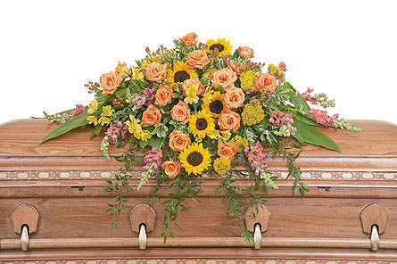 Heaven's Sunset Casket Spray - The colors of sunset are evident in this beautiful spray of Sunflowers and Roses with accents of other premium flowers and foliage. Approximately 43" wide 36" deep As Shown : TMF-702