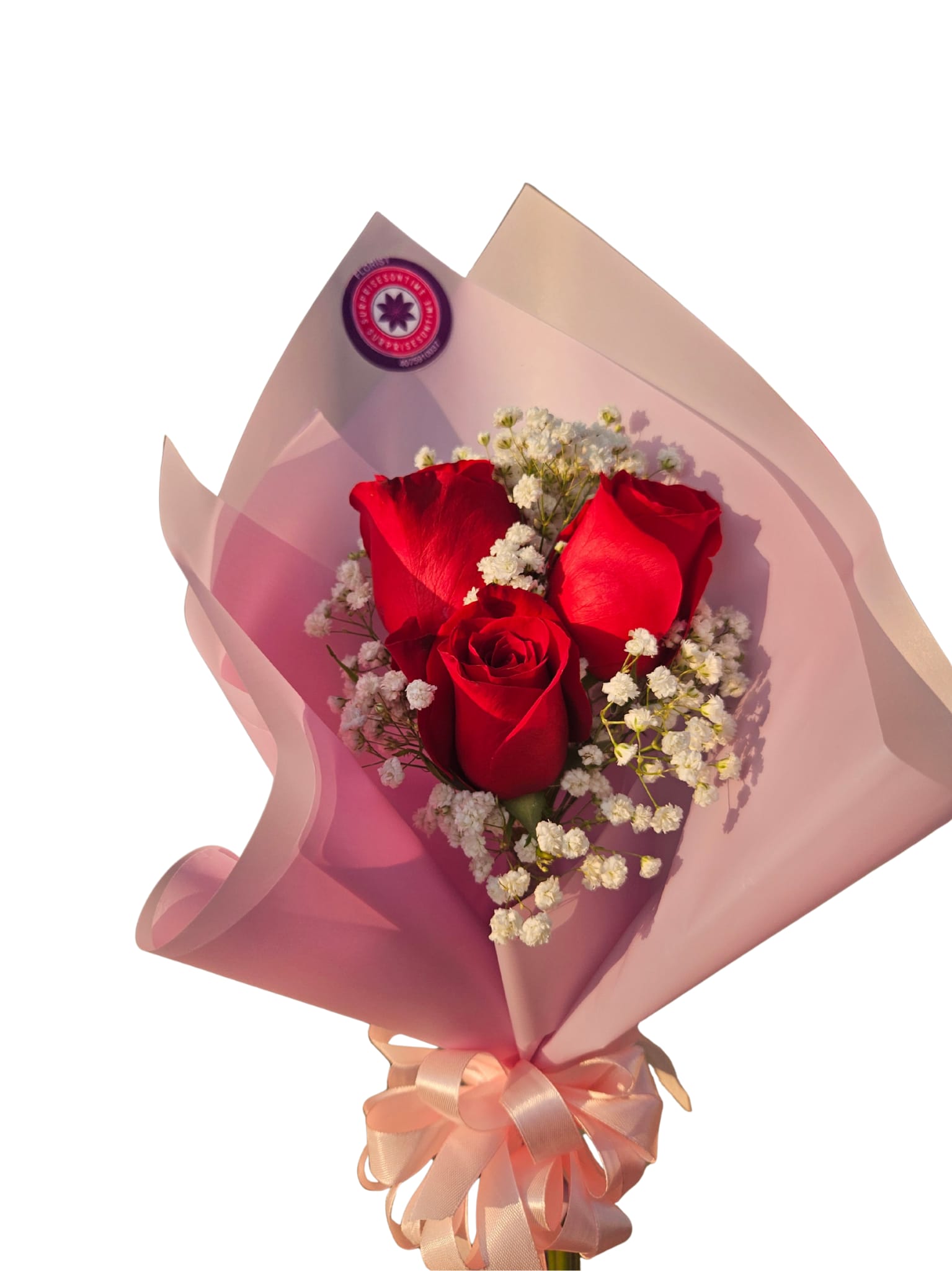 Bouquet of red roses with white baby's breath in pink wrap