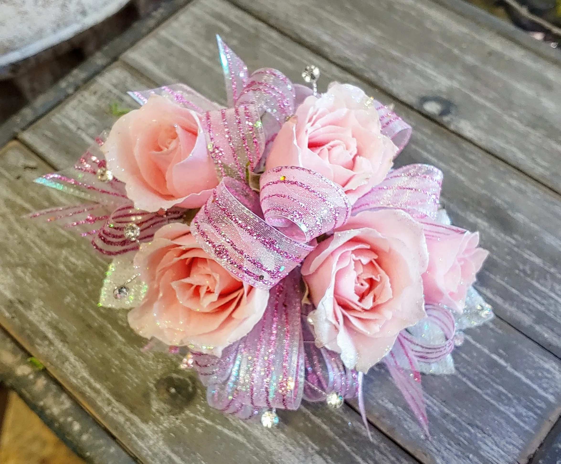 Light Pink Corsage - Light pink spray roses, filler and greenery with a bow to coordinate