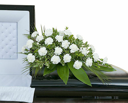 Simple Love Casket Spray - White carnation casket spray with assorted foliage. Approximately 24" wide 16" deep As Shown : TMF-744