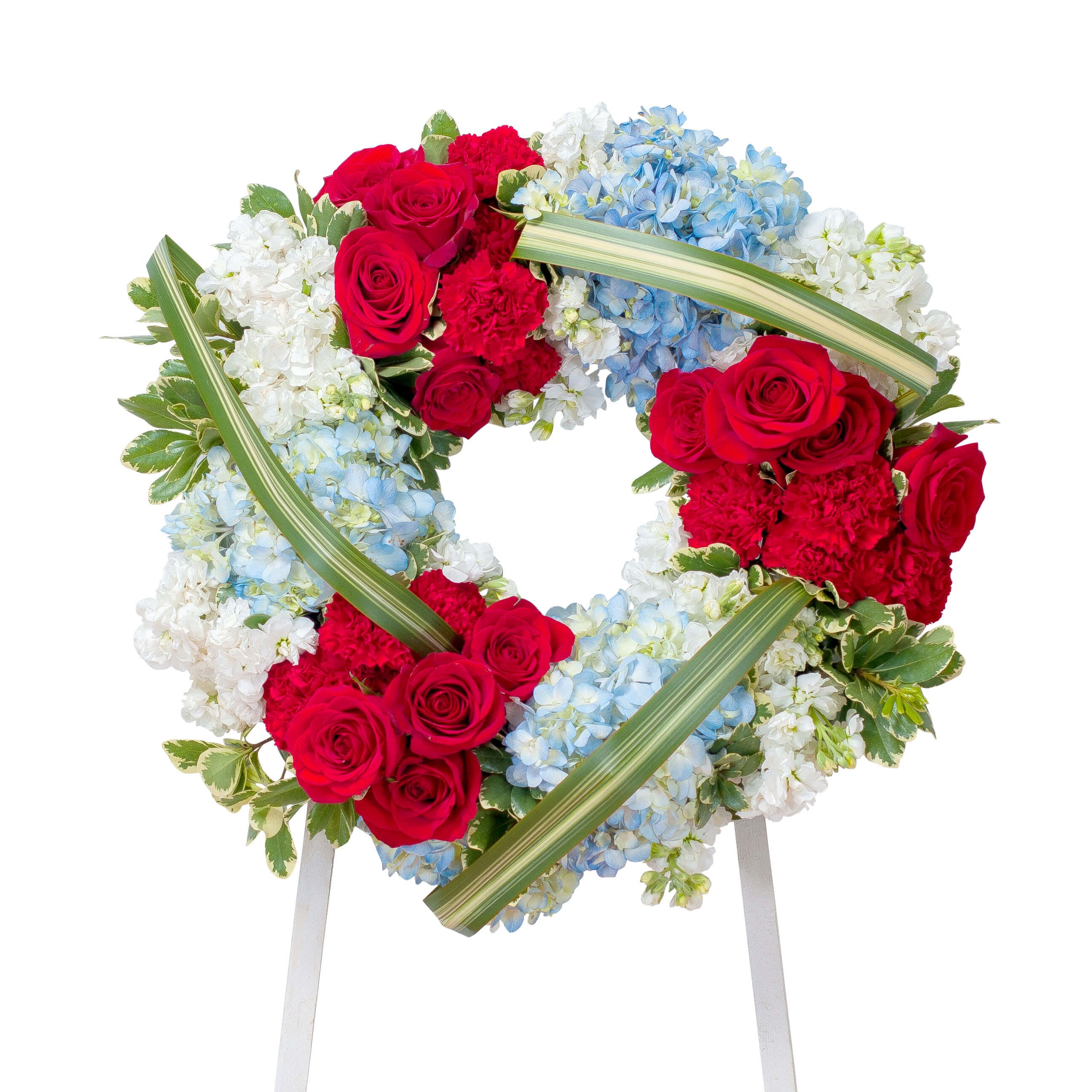The Honor Tribue - This beautiful red, white and blue casket spray gives tribute to the one who served with honor.