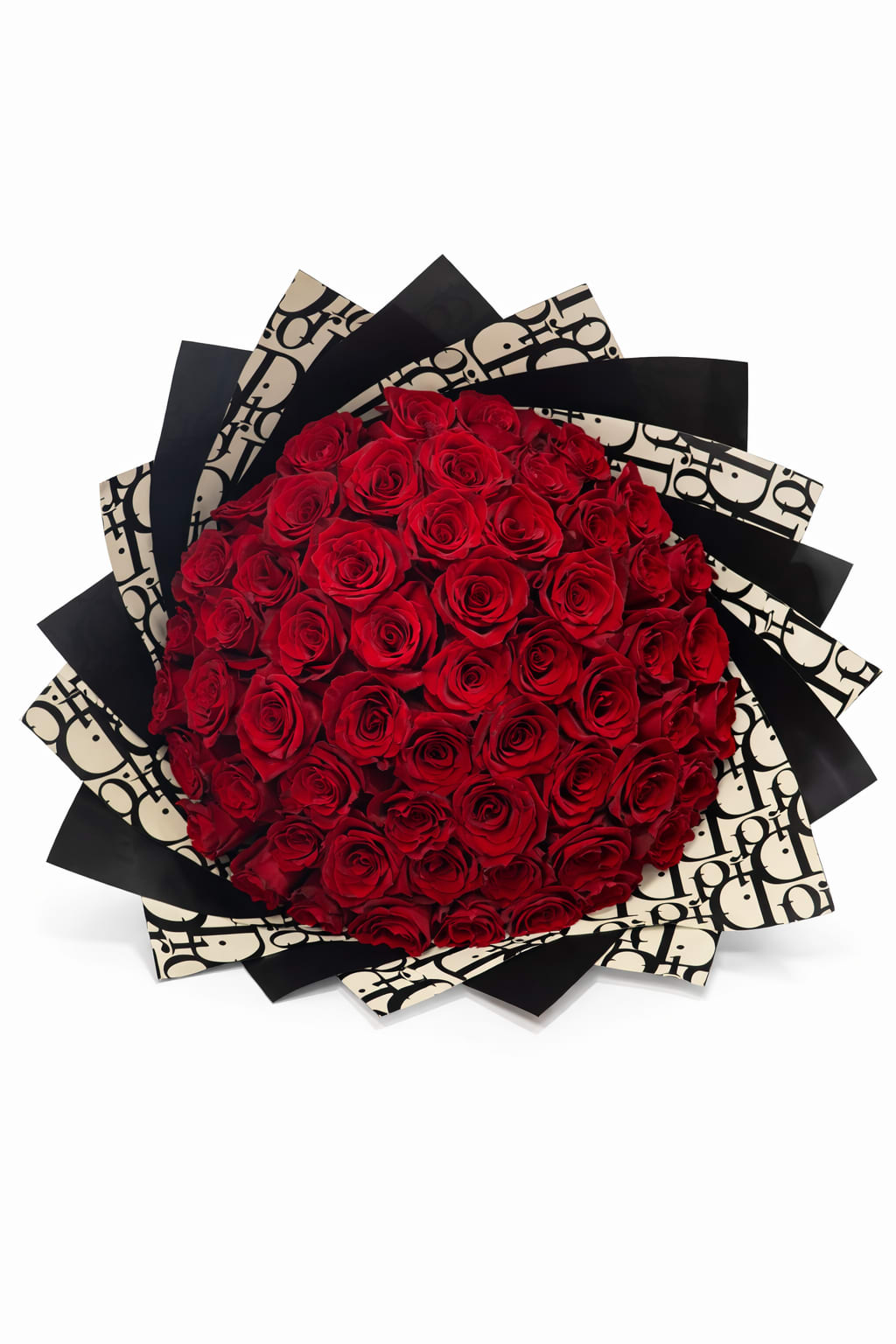 Large round bouquet of red roses wrapped in layered black and cream patterned paper