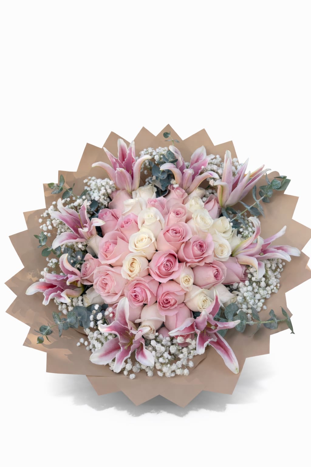 Round bouquet of pink and white roses with pink lilies and baby's breath wrapped in tan paper.