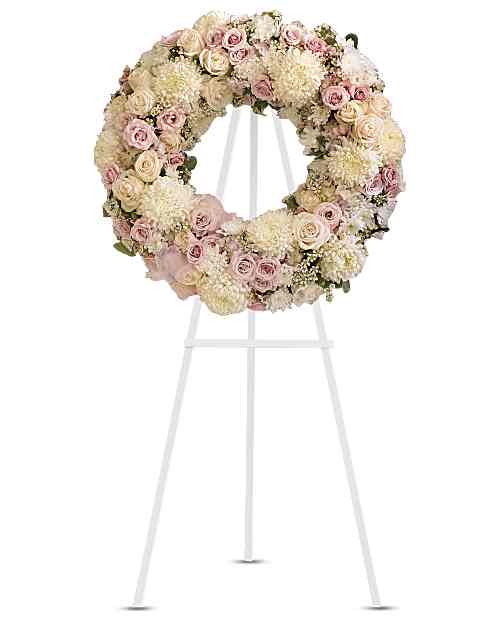 Peaceful Memories Wreath - A tender and graceful expression of love and remembrance. This wreath of white, crème, and soft pink blooms is accented with a delicate pink organza bow, offering comfort and heartfelt thoughts during a time of loss. Beautiful flowers including crème and pink roses, pink hydrangea, and white chrysanthemums are thoughtfully arranged and complemented with the organza ribbon. A touching, feminine tribute, perfect for a memorial service.