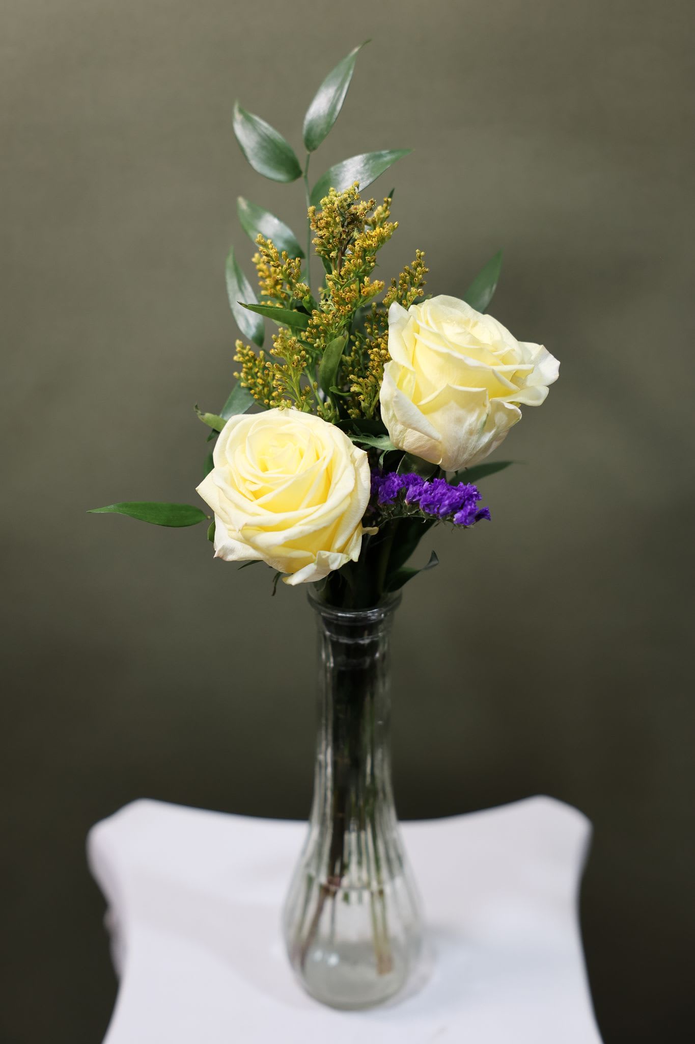 Dainty duo  - Two beautiful roses arranged with fresh greenery in a petite vase. This sweet and simple design is perfect for a small gesture, a desk arrangement, or sending a little love just because.
