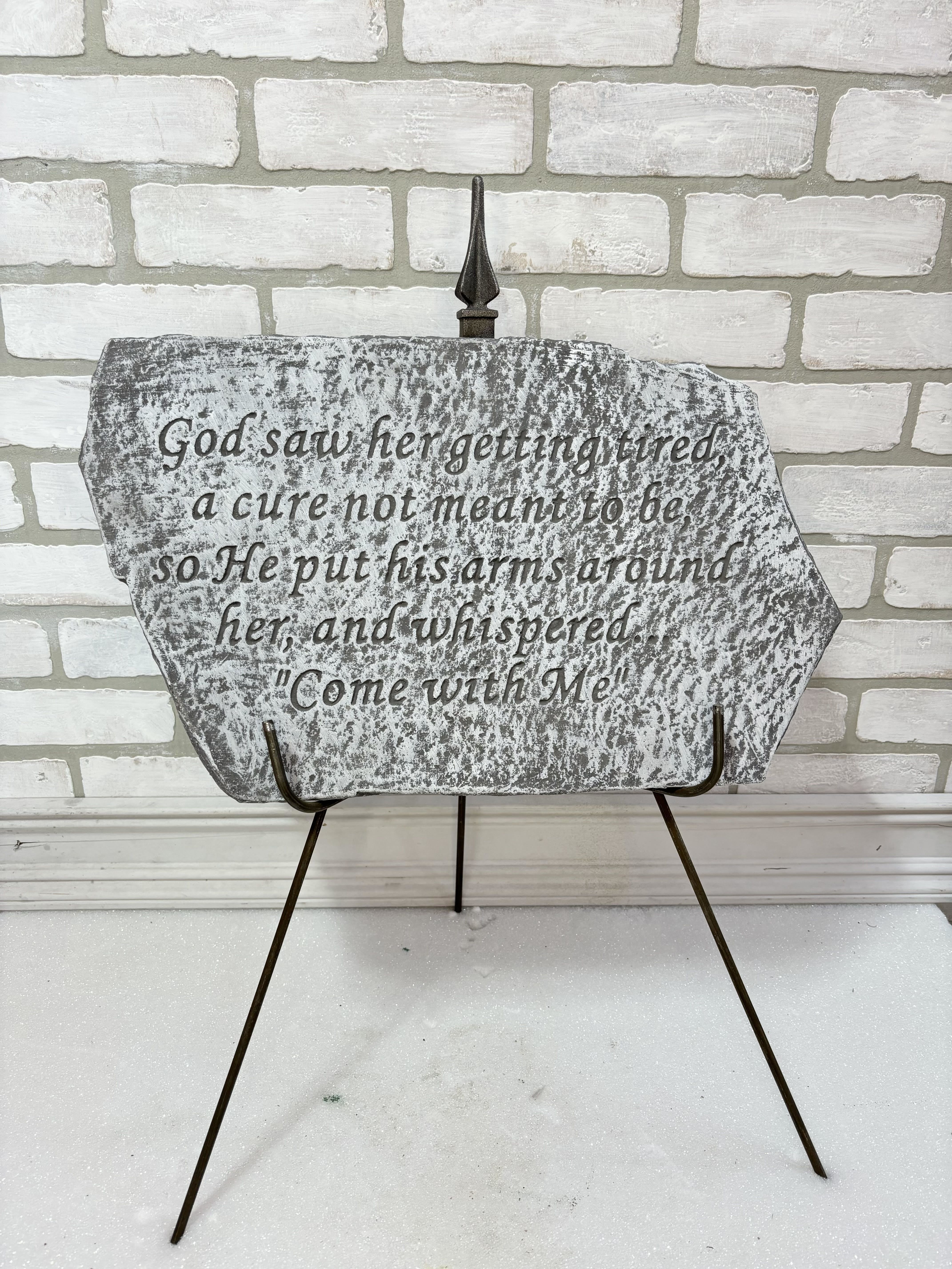 Decorative memorial plaque on a metal stand with a Bible verse