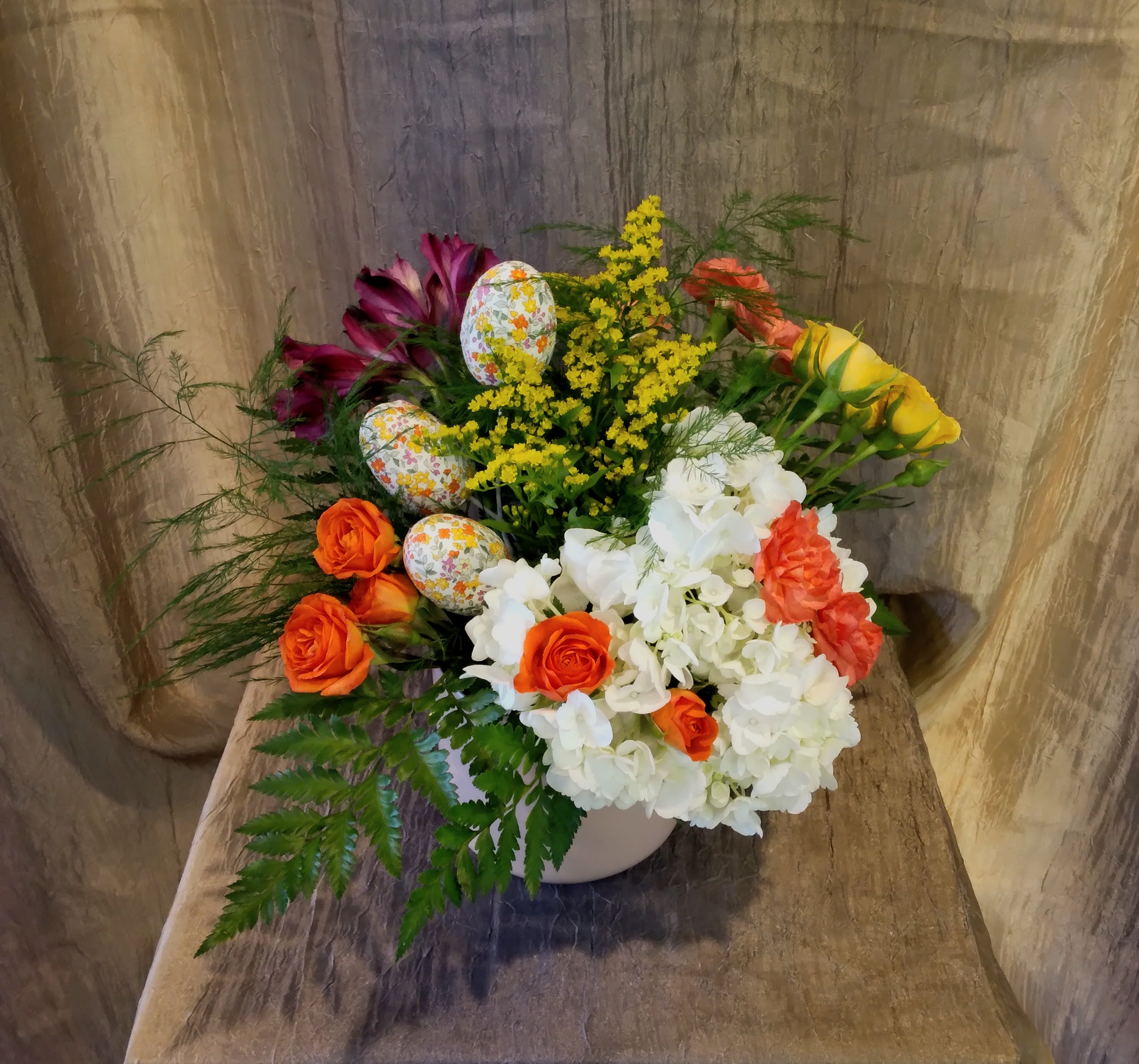 Easter Egg Excitement ~ Flower A Day - This colorful arrangement has inserts of colorful Easter Eggs, surrounded by bright colored blooms and lush foliage. 