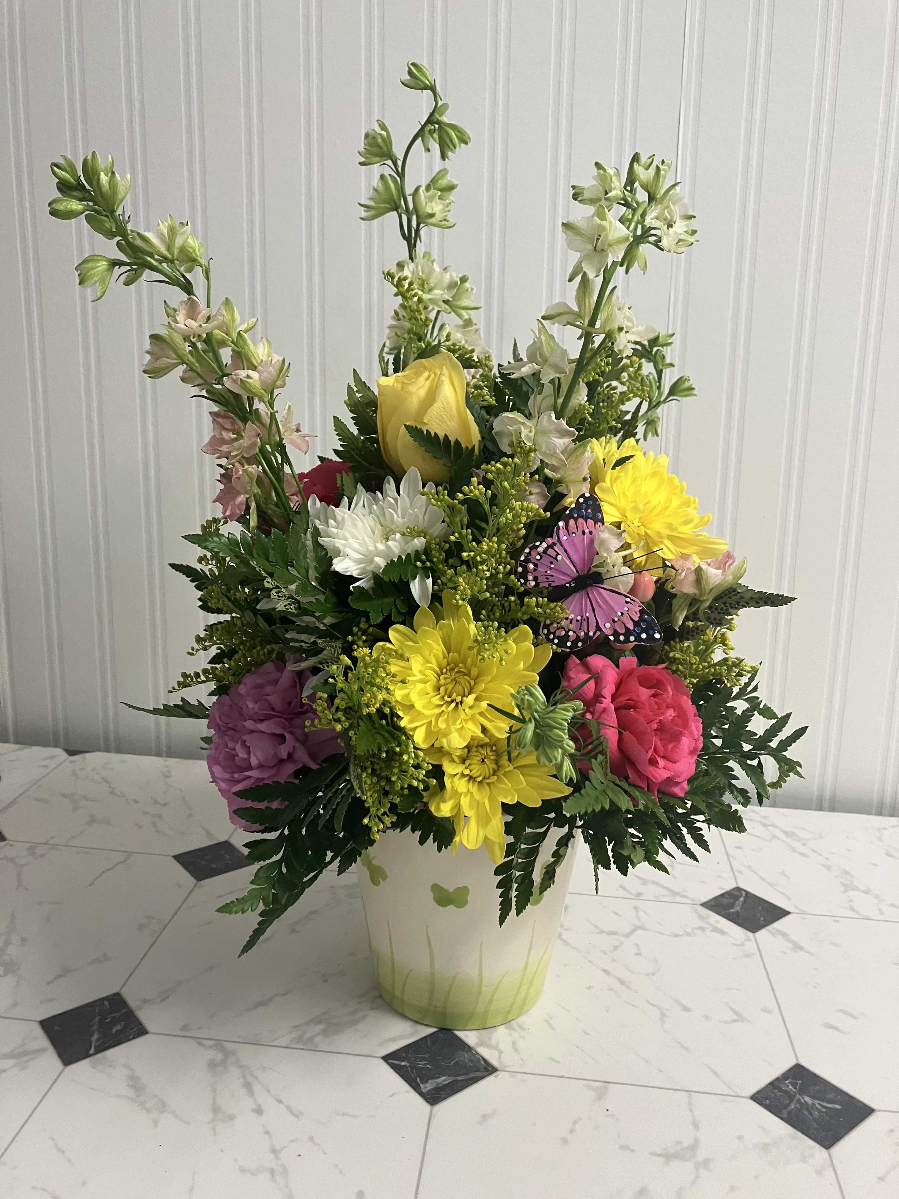 Love Is Like A Butterfly - Soft pastels and gentle blooms in a ceramic butterfly fields container—delicate, dreamy, and light as the lyrics themselves.  Container color may vary, but the soft palette will stay true.