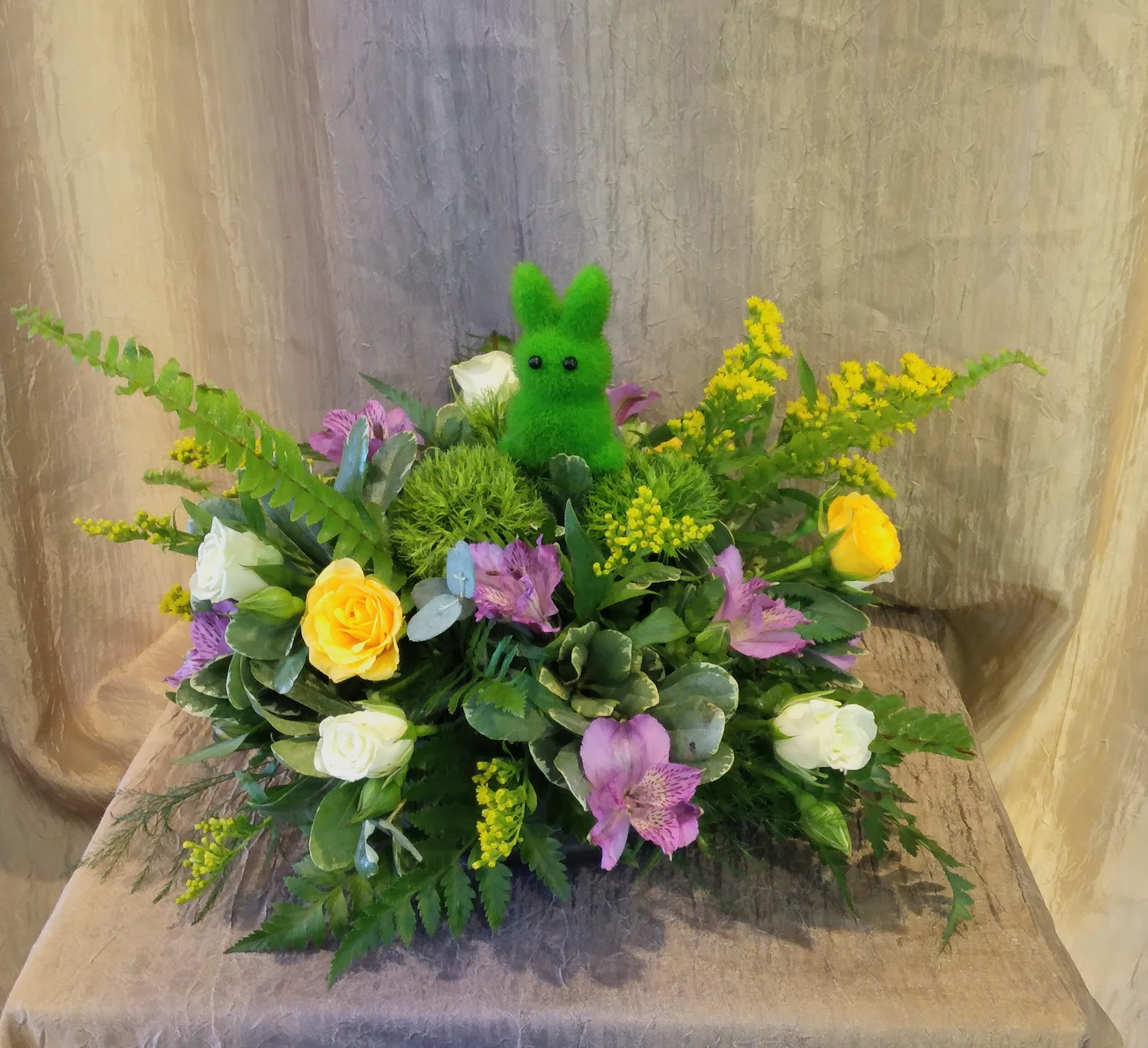 Hoppy Easter Centerpiece ~ Flower A Day - This arrangement features a Bunny insert, Easter colored blooms and lush foliage in a low centerpiece dish, perfect for any table! 