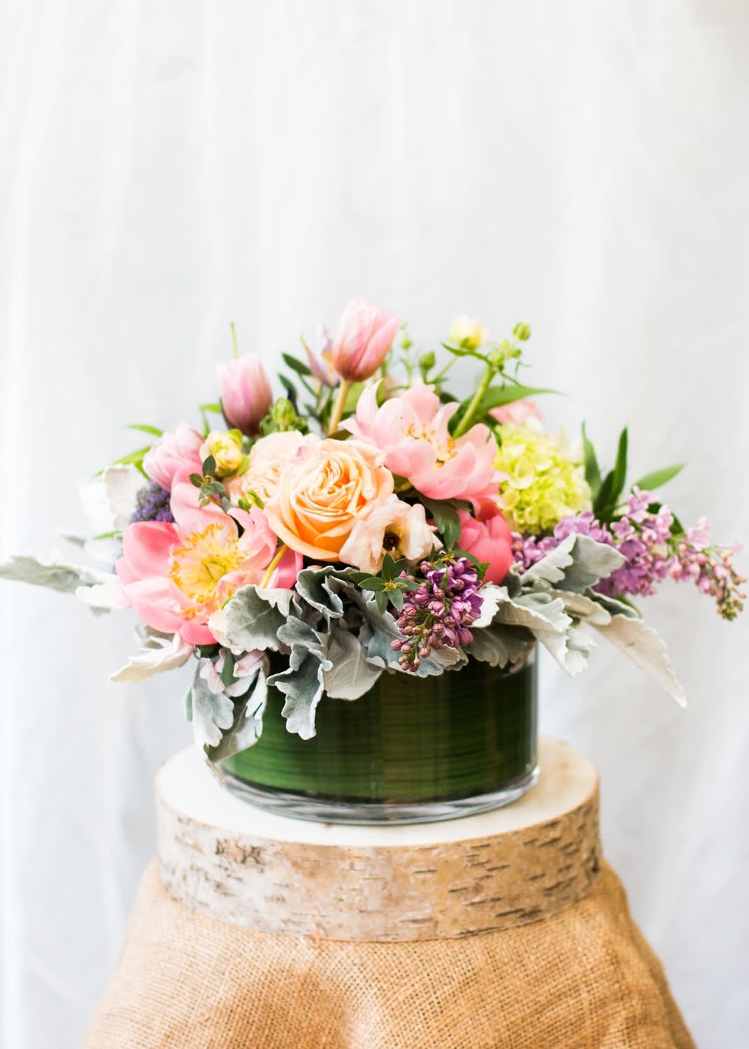 Spring Abundance  - Appprox 14”x14” This lush design lends itself perfectly to a more special occasion. This size is appropriate as a dining table centerpiece, kitchen island accent and anniversary gesture.  Arrangement may not included flowers pictured. We focus on using a palette inspired by the current season.