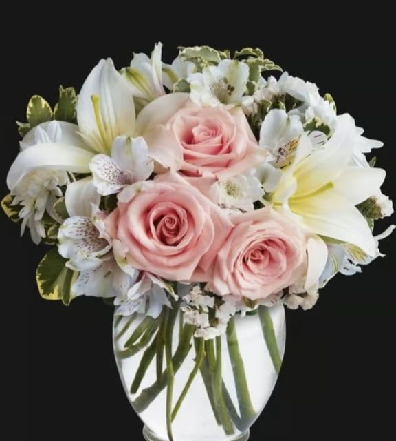 Lovely - Vibrant lilies, delicate pink alstroemeria, and lush green branches.