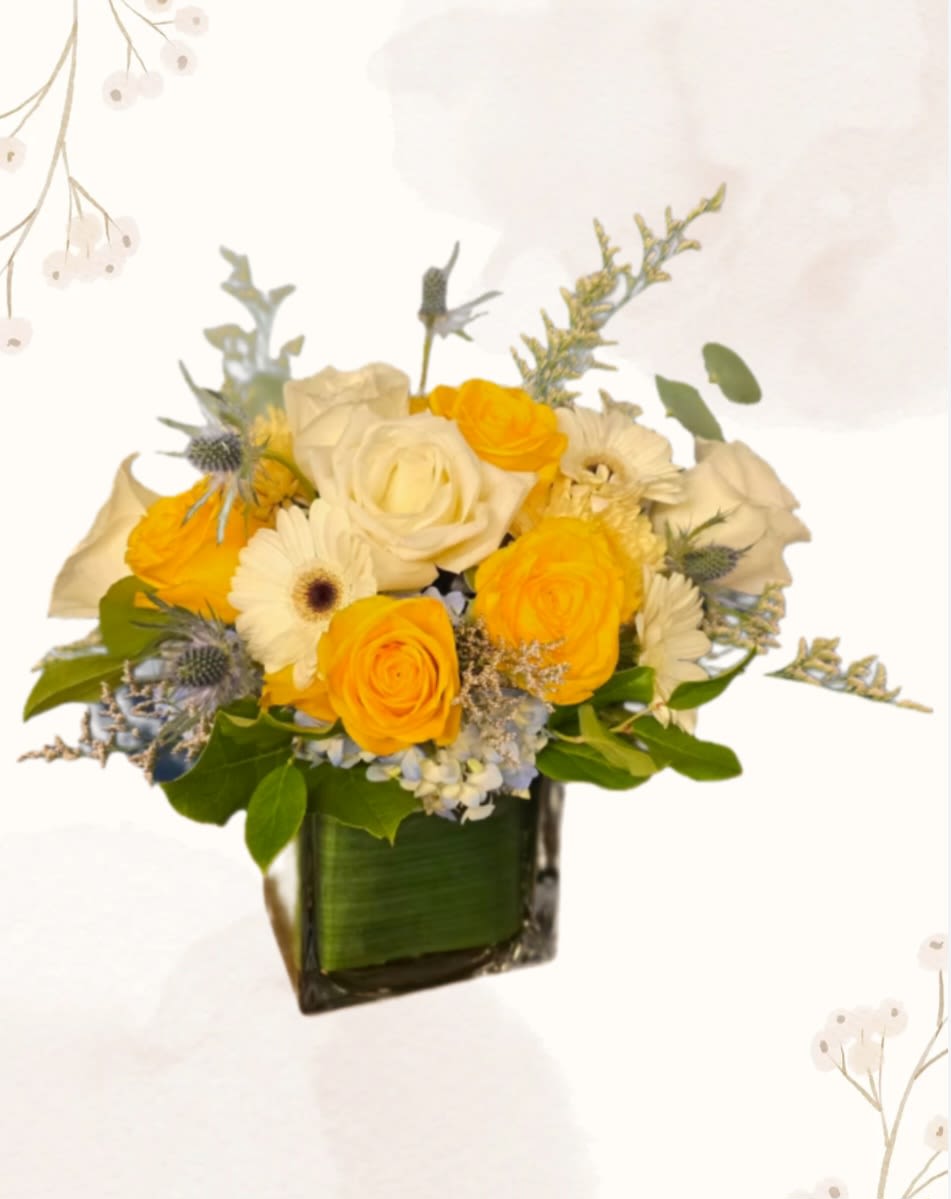 Sunny Days - Yellow roses, blue hydrangea and cheerful gerber daisies make up the perfect arrangement to bring sunshine to anyone's day.