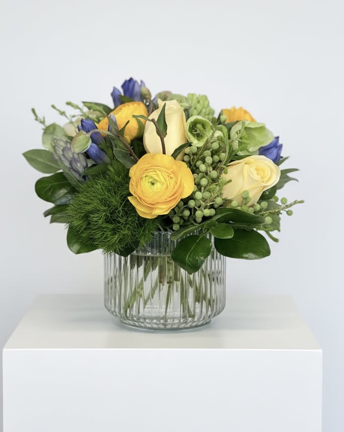 Radiant Blue - Happy blue and yellow spring blooms: ranunculus, hyacinths, roses and a pop of green diathus
