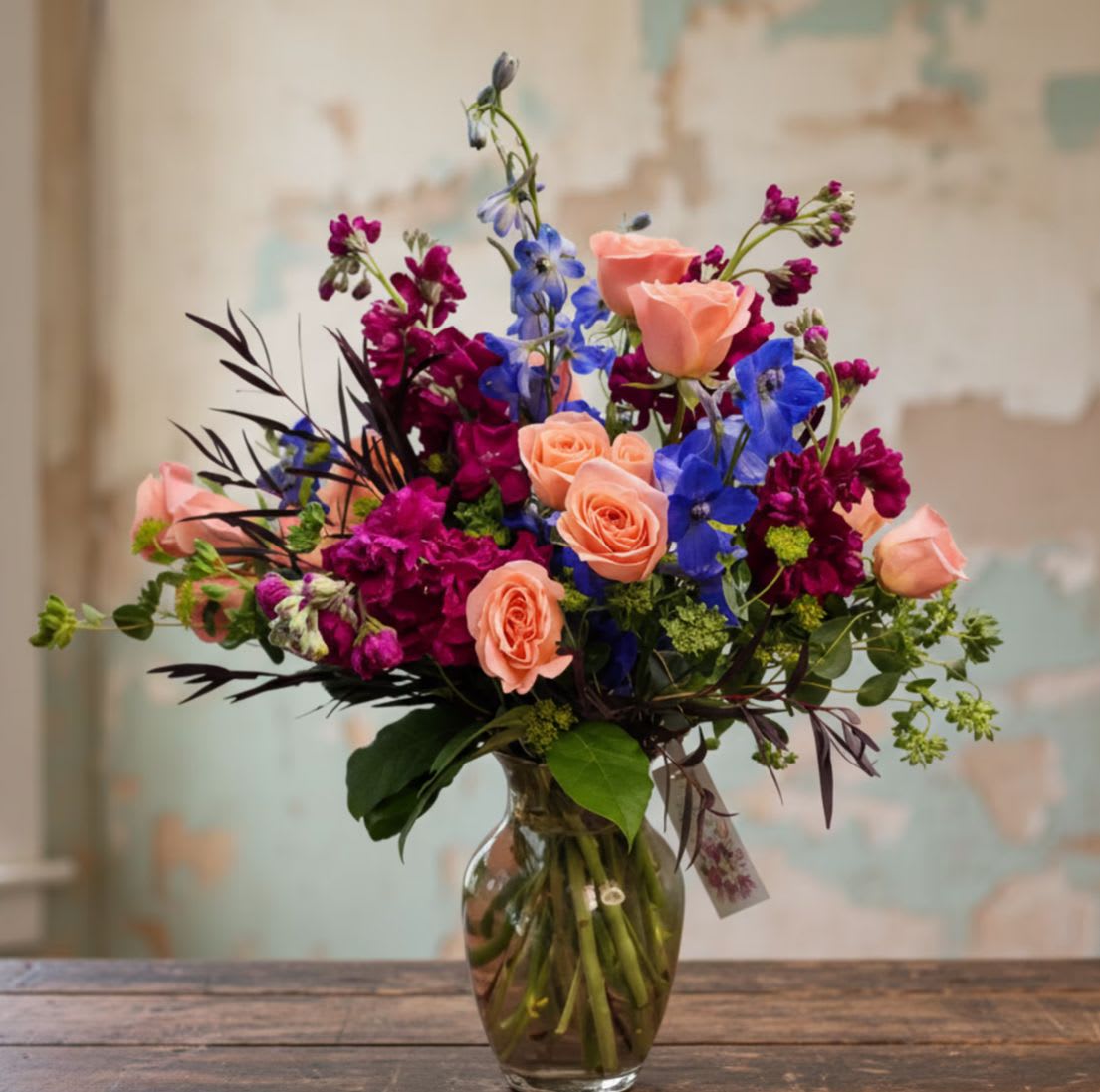 East Meets West - Where elegance meets balance, East Meets West blends the refined simplicity of Eastern design with the lush beauty of Western florals. This unique arrangement combines graceful lines, natural movement, and thoughtfully placed blooms to create a look that feels both modern and timeless.  With a harmonious mix of textures, greenery, and carefully selected flowers, East Meets West highlights the beauty of contrast—structured yet organic, minimal yet full of life. The result is a striking arrangement that brings calm, sophistication, and artistry to any space.