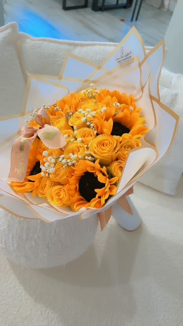Sunshine  and Roses - An explosion of light, color, and love this radiant arrangement blends the warmth of sunflowers with the elegance of rosesv