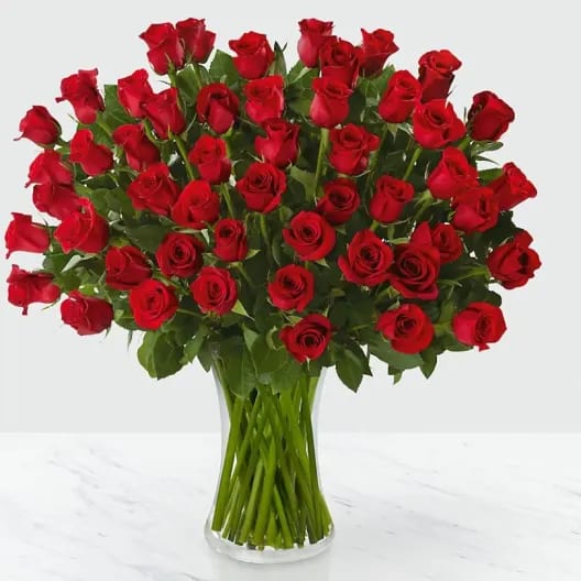 50 red Roses - 50 beautiful 70cm tall red roses cartistically adorned with lemon leaf and assorted greenery as to not take away from the red beauties. ***Other colors may be available upon request.